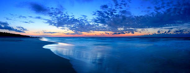 Sunset over Lake Atitlan with volcano backdrop, ideal for travelers budgeting for scenic experiences.
