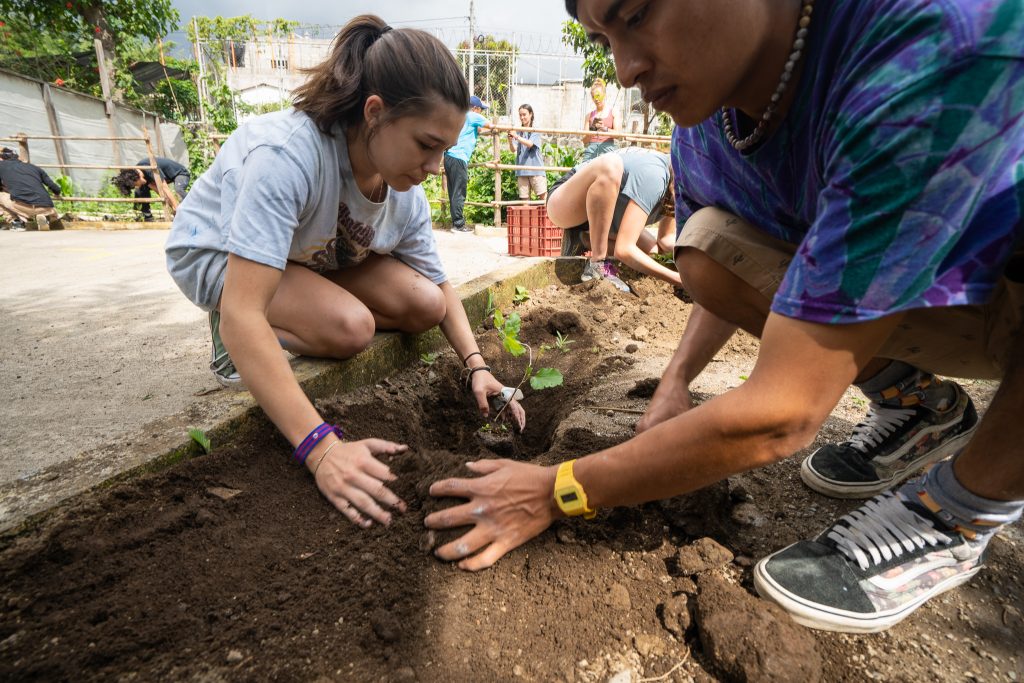 Students planting trees with Wellkind Guatemala staff