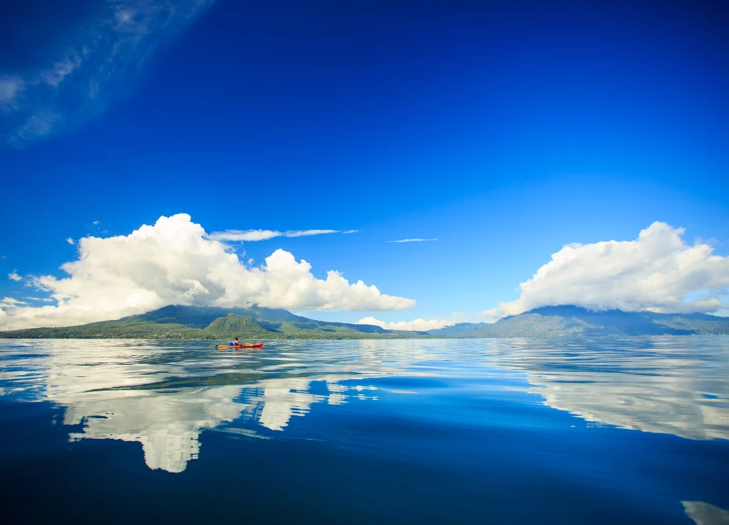 Family kayaking with volcano views