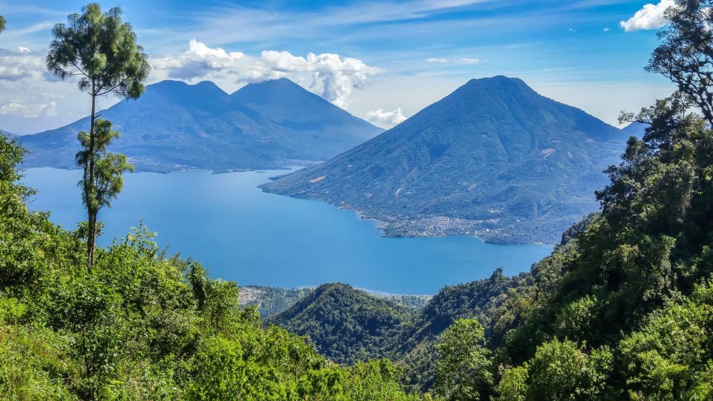 Dry and rainy season comparison at Lake Atitlán with volcano backdrop