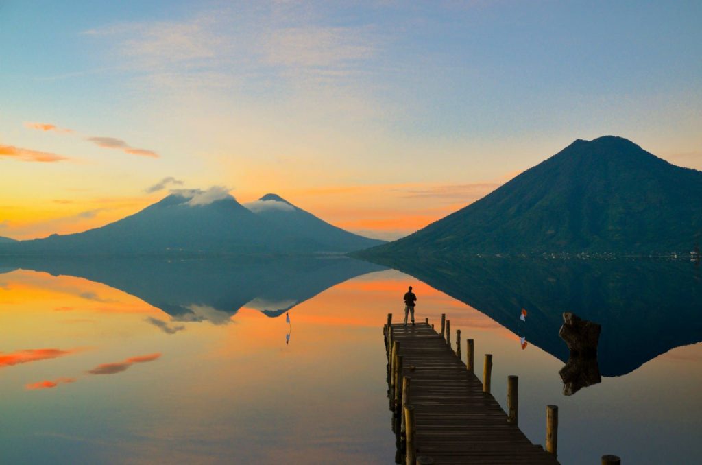 Lake Atitlán in January with bright sunshine and clear volcano views