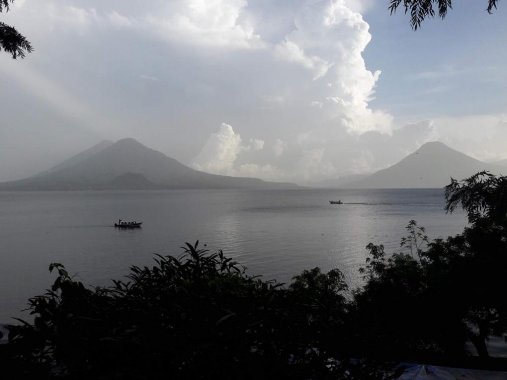 Afternoon rain clouds forming above Lake Atitlán during rainy season