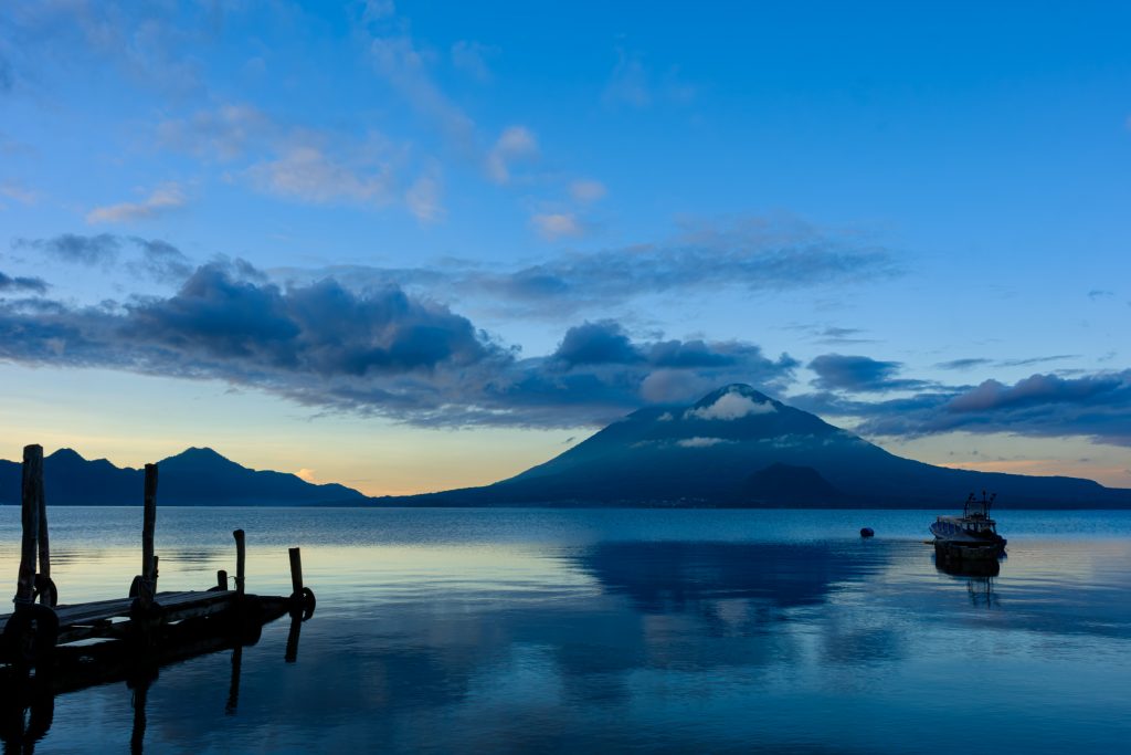 Sunrise view over Lake Atitlán with volcanoes in the background